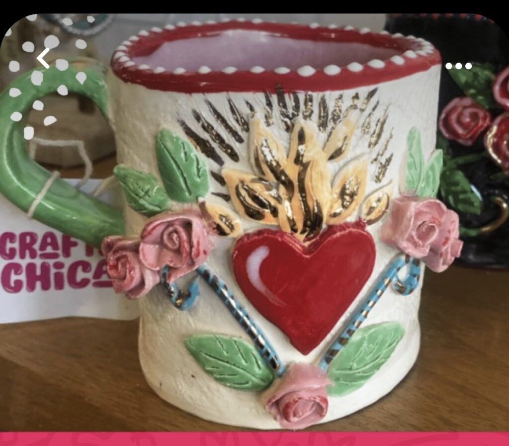 Handmade cup with a heart and roses.